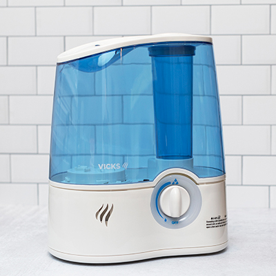 VICKS<sup>&reg;</sup> Ultrasonic Humidifier - This humidifier quietly produces an ultra-fine visible mist, helping to return essential moisture to dry air for better breathing and a comfortable sleep. Variable Mist Controls give you the ability to adjust the output for customized control. Its convenient design is equipped with a demineralization cartridge and a 1.5 gallon water tank that operates up to 24 hours per filling. Large tank opening for easy filling and cleaning. 